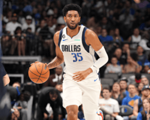 Christioan Wood runs on the court with basketball.