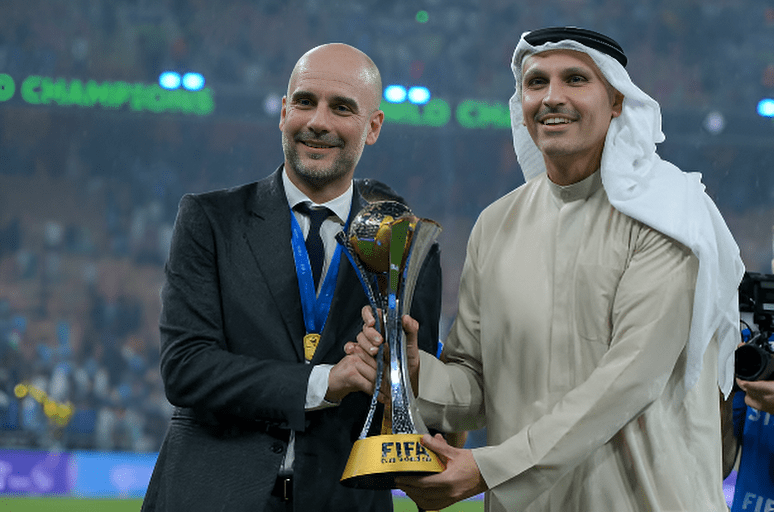 Pep Guardiola Manager of Manchester City and Manchester City chairman Khaldoon Al Mubarak pose with the FIFA Club World Cup Trophy after the FIFA Club World Cup Final between Manchester City and Fluminense at King Abdullah Sports City