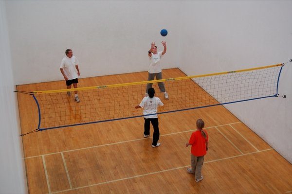 Wallyball is playing in an indoor.