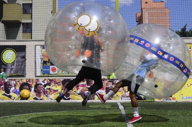 Two people playing Bubble soccer an Unusual game.