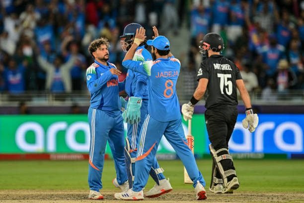 Kuldeep Yadav of India celebrates the wicket of Daryl Mitchell.
